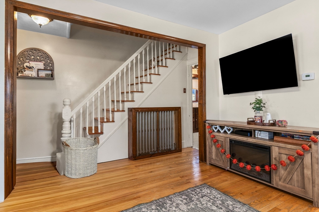 65 Poplar Street Gloucester, MA 01930 - Photo 8 of 23 a living room with fireplace furniture and a flat screen tv