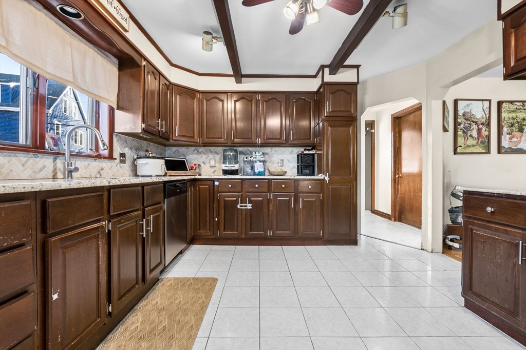 65 Poplar Street Gloucester, MA 01930 - Photo 9 of 23 a kitchen with stainless steel appliances granite countertop a sink counter space cabinets and a stove