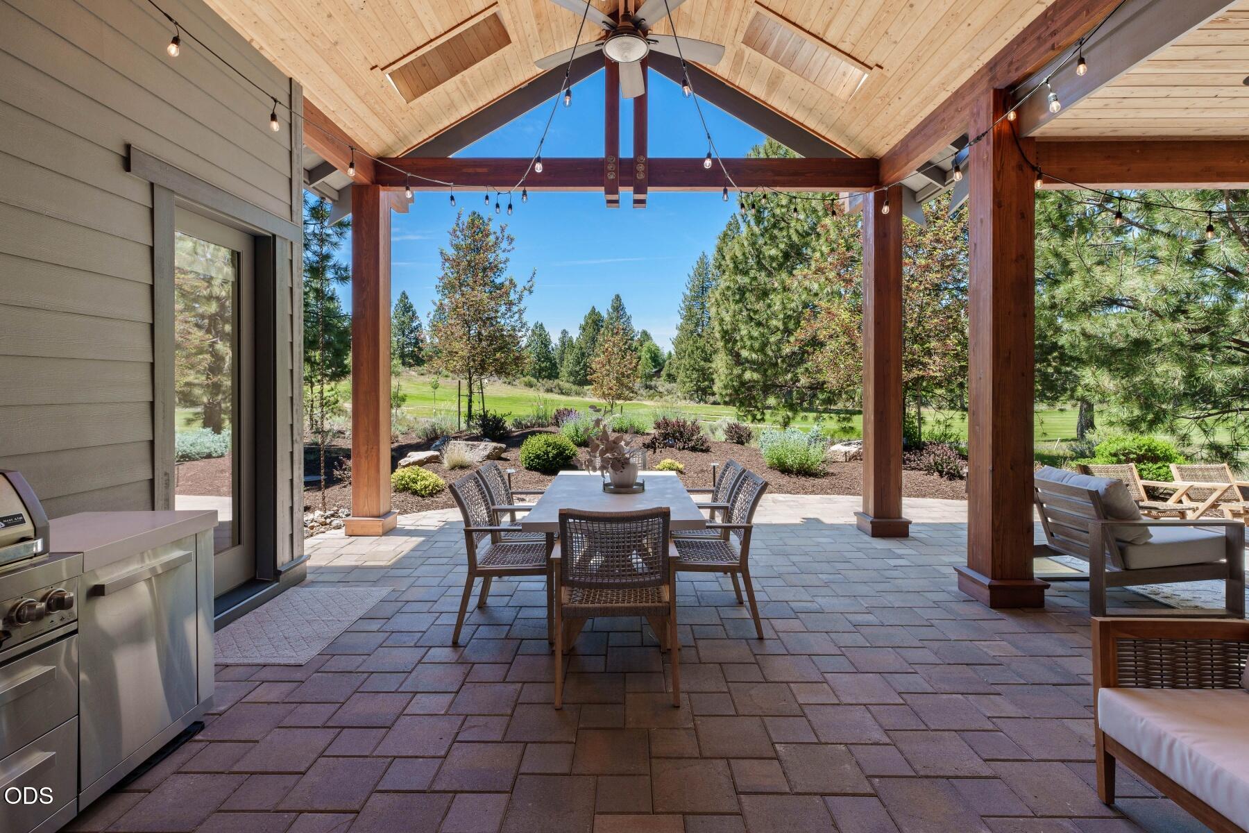 60255 Sunset View Drive Bend, OR 97702 - Photo 36 of 48 a view of a patio with a dining table and chairs
