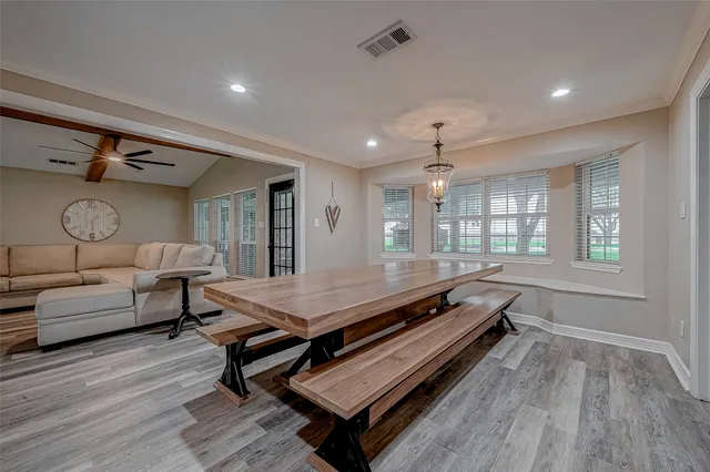 a large hall with stainless steel appliances granite countertop a lot of counter space