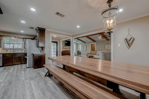 a spacious bedroom with a bed and a flat screen tv