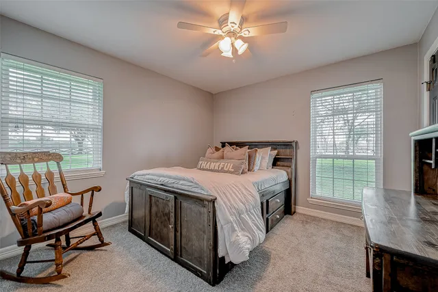 a room with furniture pool table and window