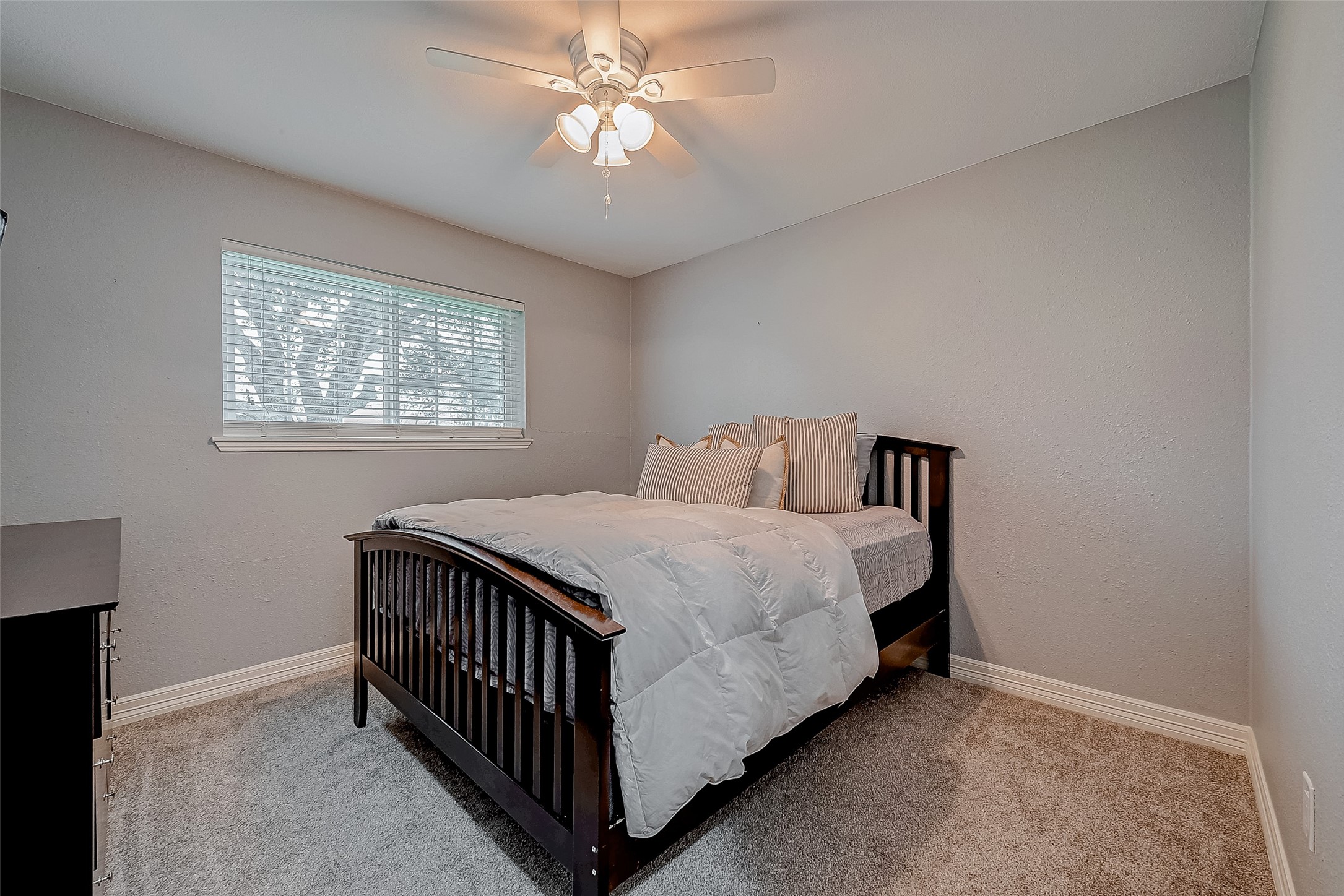 3819 Cottonwood School Road Rosenberg, TX 77471 - Photo 21 of 37 a bedroom with a bed and a chandelier