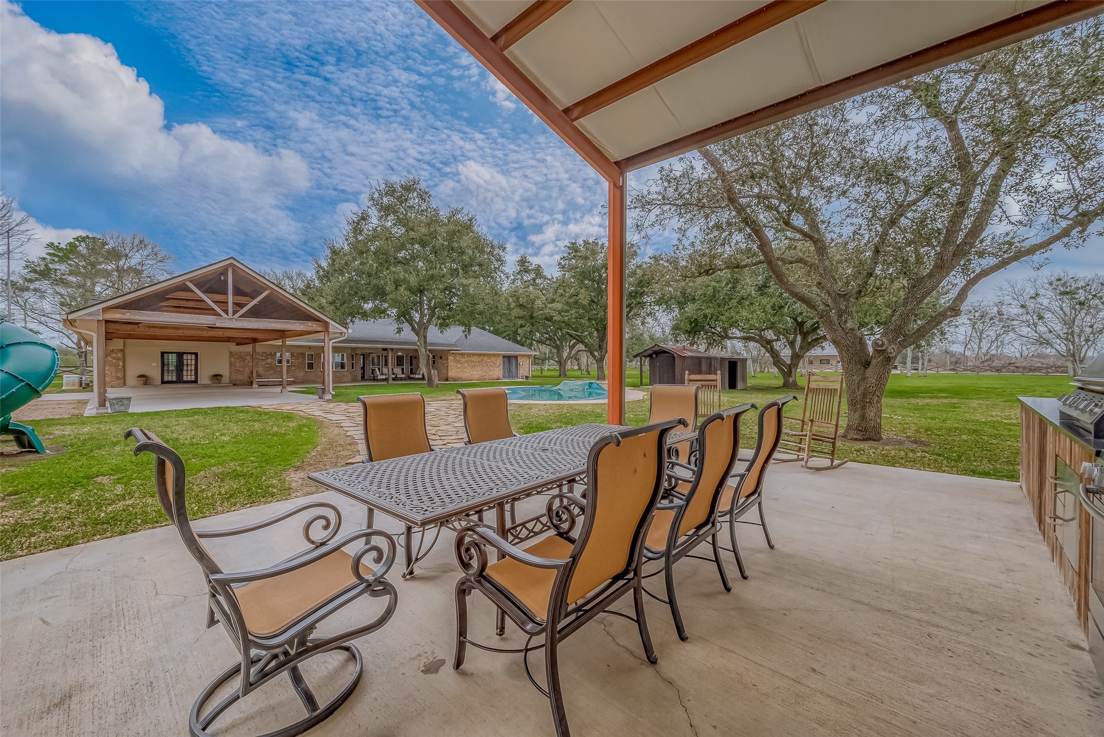 3819 Cottonwood School Road Rosenberg, TX 77471 - Photo 30 of 37 a view of a patio with a table chairs and a yard