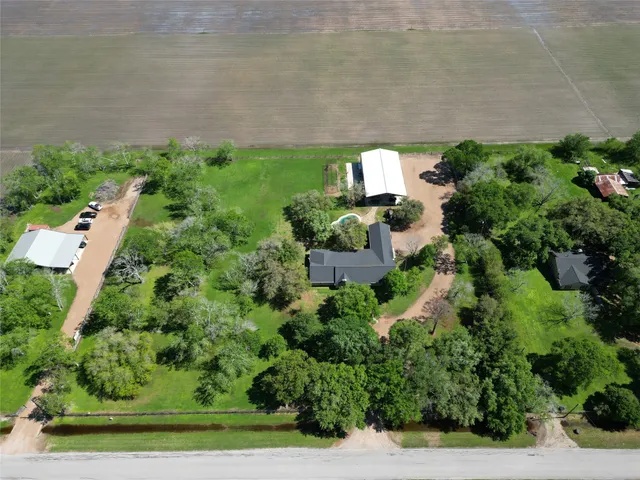 an aerial view of a house with a yard