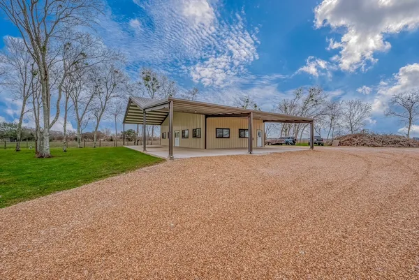 a view of house with backyard and road
