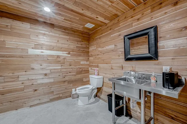a backyard of a house with plants and large trees