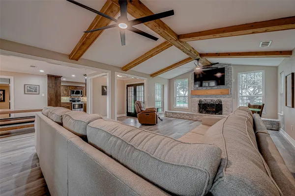 a living room with furniture and a wooden floor