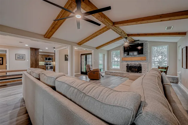 a living room with furniture and a wooden floor