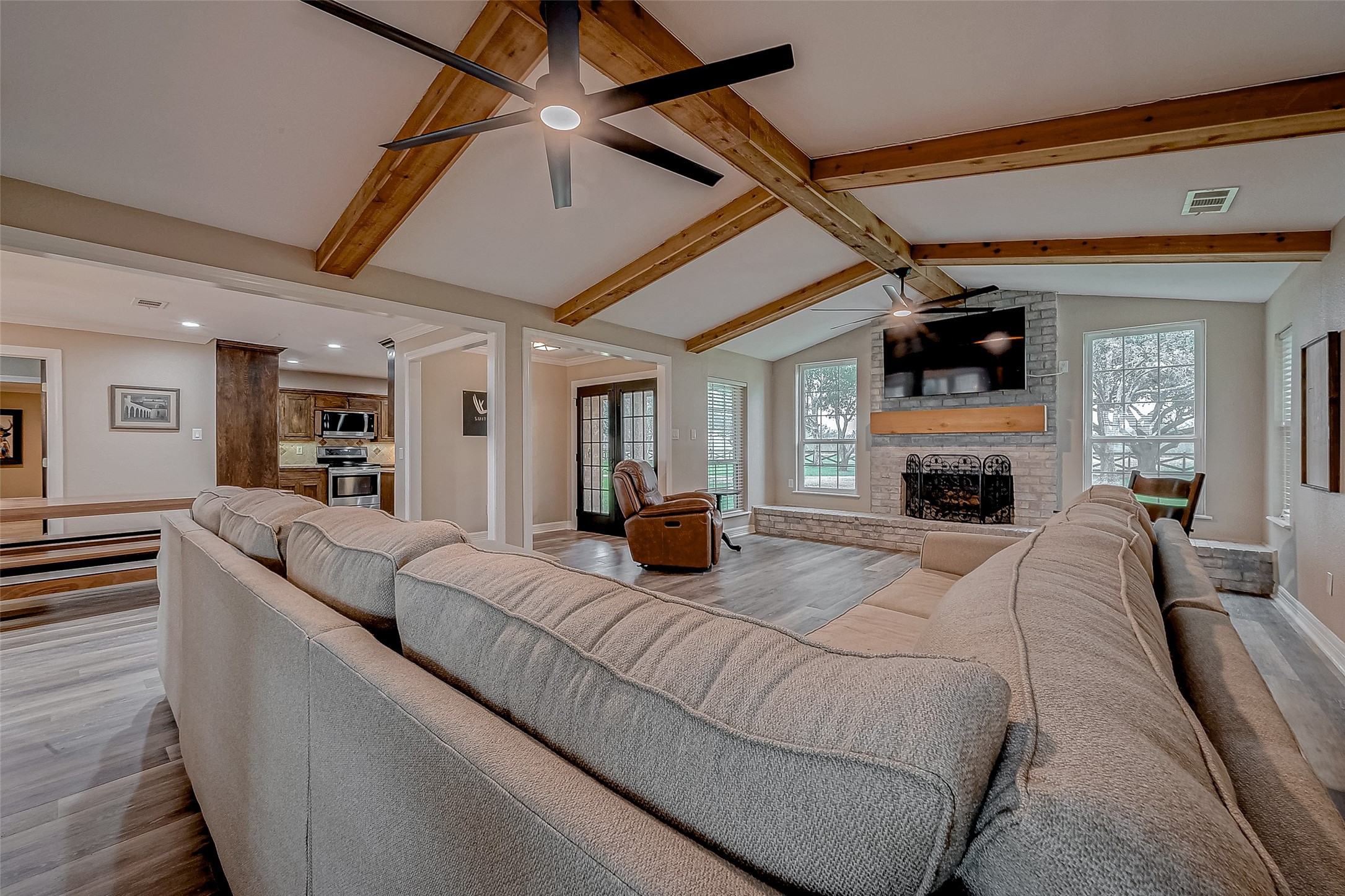 3819 Cottonwood School Road Rosenberg, TX 77471 - Photo 7 of 37 a living room with furniture a fireplace and a flat screen tv