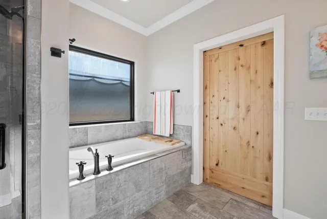 a bathroom with a bathtub and a sink