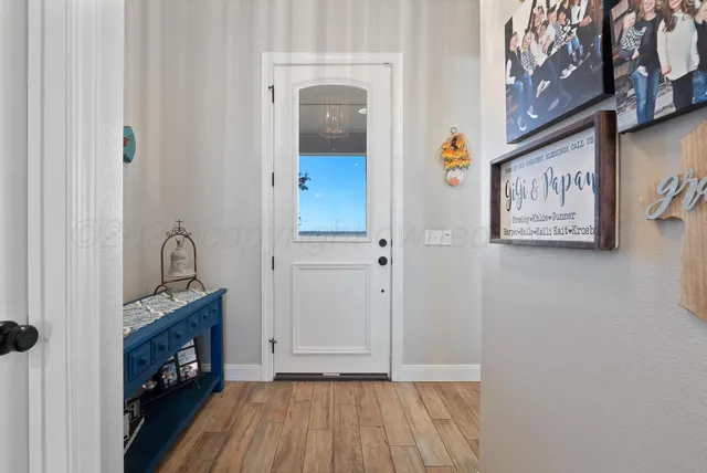 a bedroom with a bed a desk and chair with window