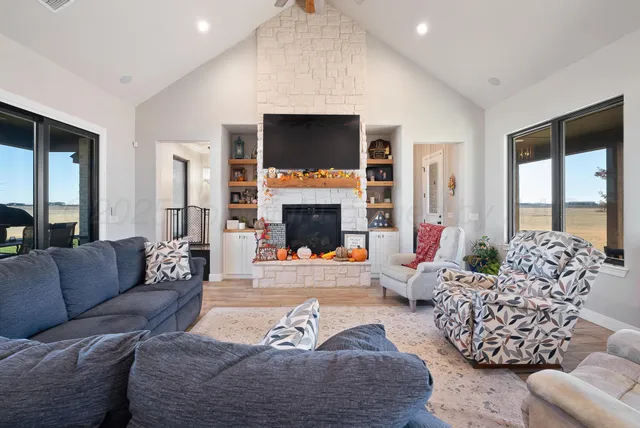 a living room with furniture fireplace and flat screen tv