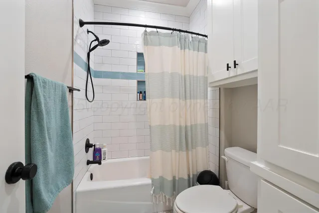 a bathroom with a granite countertop sink mirror and shower