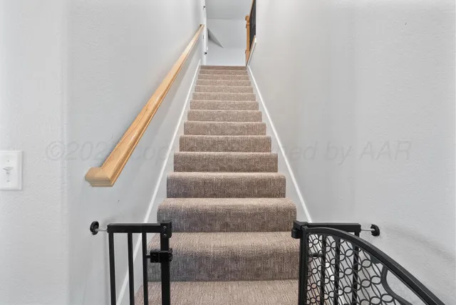 a bedroom with furniture a flat screen tv and a chandelier fan