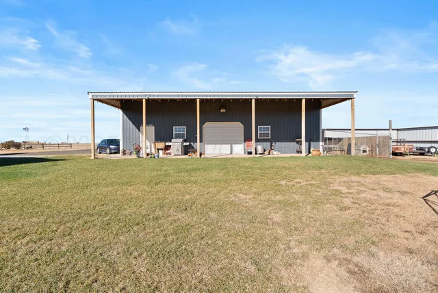 a view of a backyard with an outdoor space and seating area