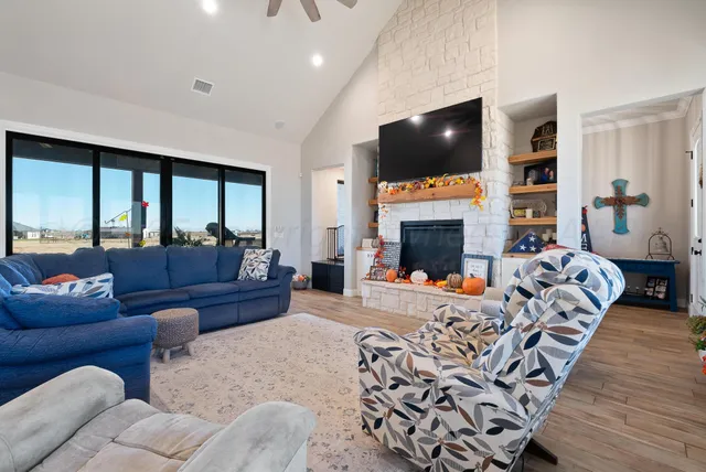 a living room with furniture fireplace and flat screen tv