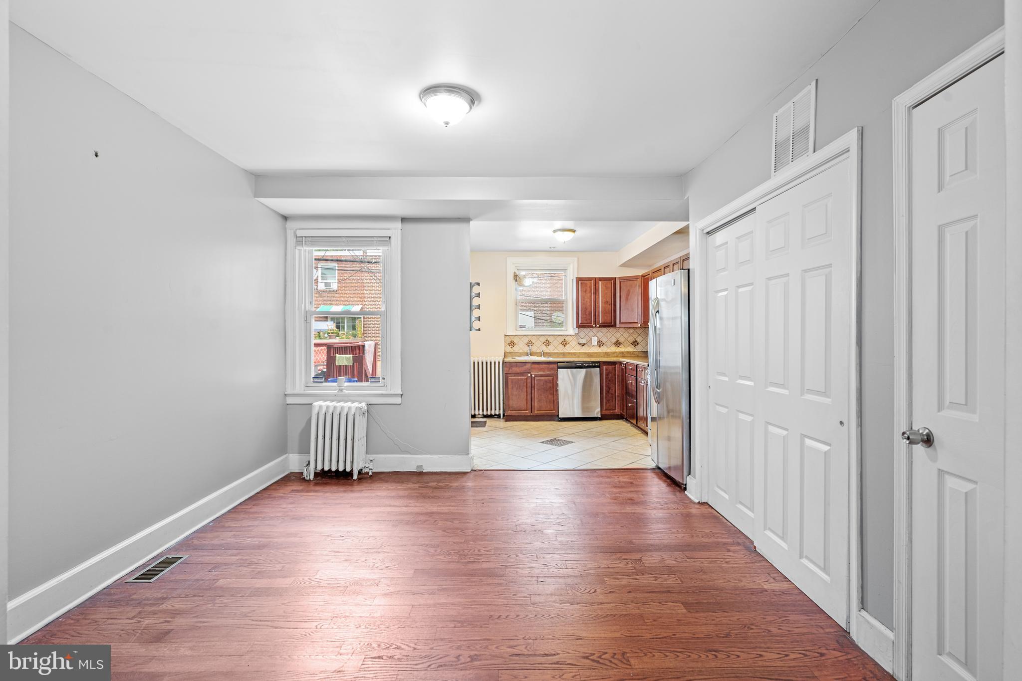 305 Margate Road Upper Darby, PA 19082 - Photo 4 of 20 an empty room with wooden floor and windows