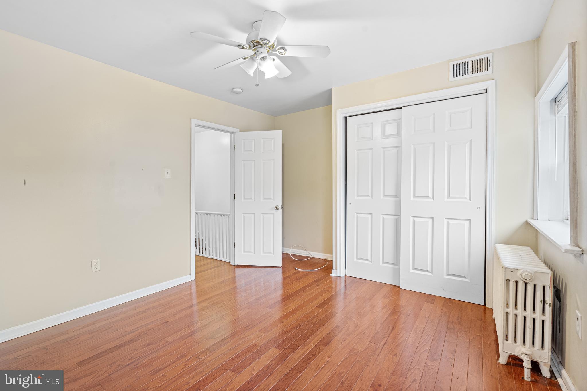 305 Margate Road Upper Darby, PA 19082 - Photo 10 of 20 an empty room with wooden floor and windows