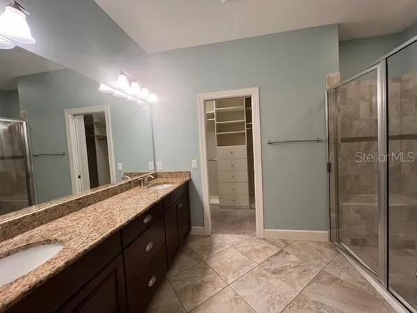 a bathroom with a granite countertop sink mirror and double