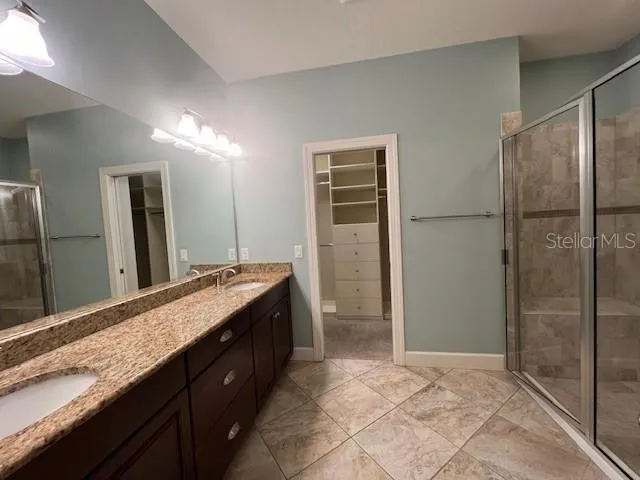 a bathroom with a granite countertop sink mirror and double