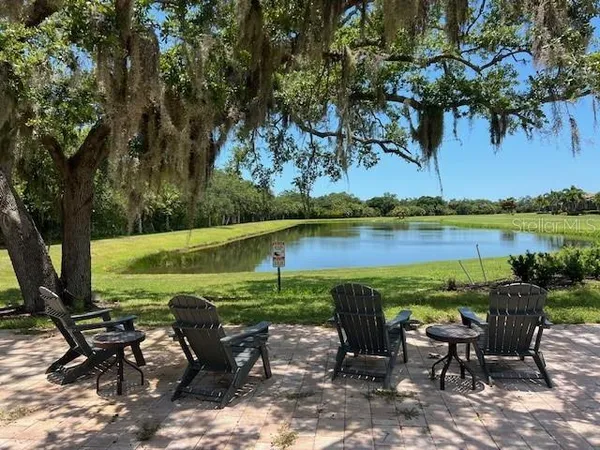 a view of a lake with a table and chairs
