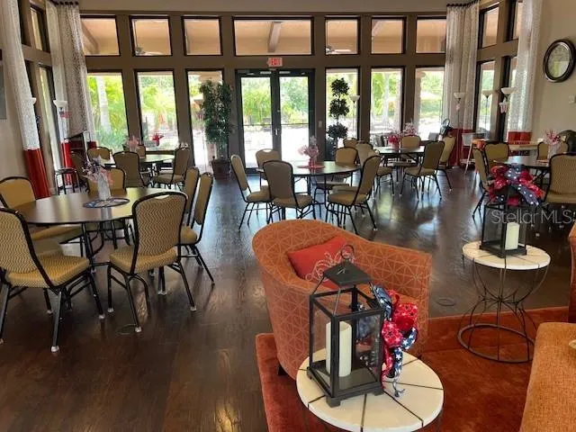 a dining room with furniture window and wooden floor