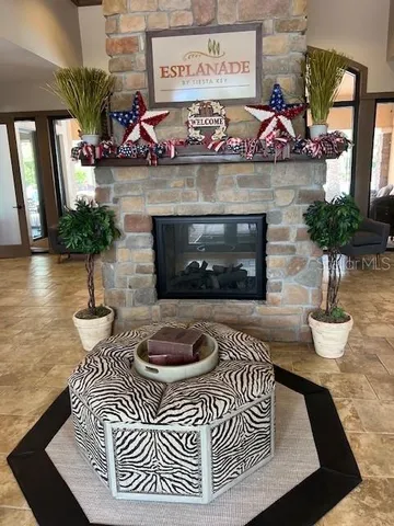 a front view of a house with entryway potted plants and a fireplace