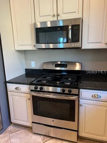 a stove top oven sitting inside of a kitchen