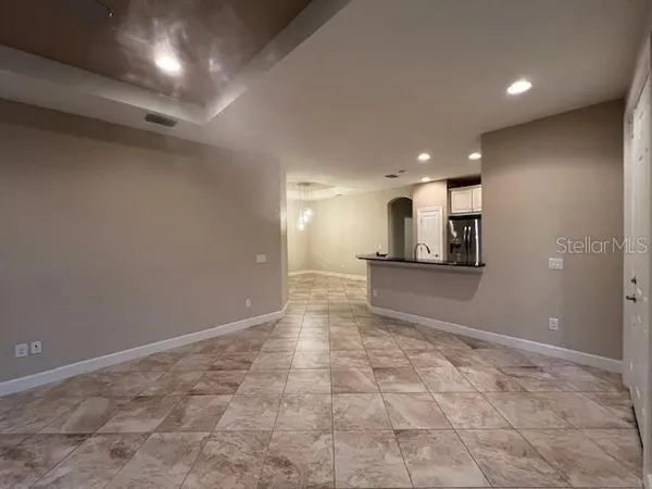 a view of a kitchen with a sink and a refrigerator