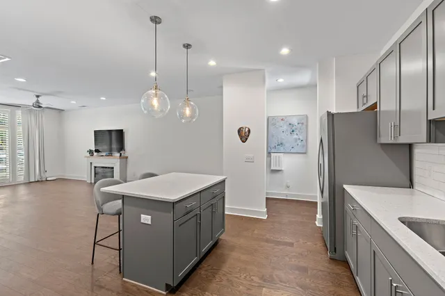 a kitchen that has a lot of cabinets and stainless steel appliances