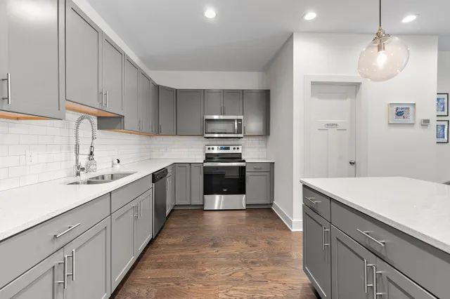 a kitchen with a sink and white cabinets