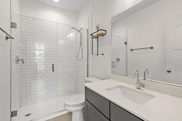 a bathroom with a sink toilet and shower