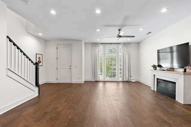 an empty room with wooden floor and a fireplace
