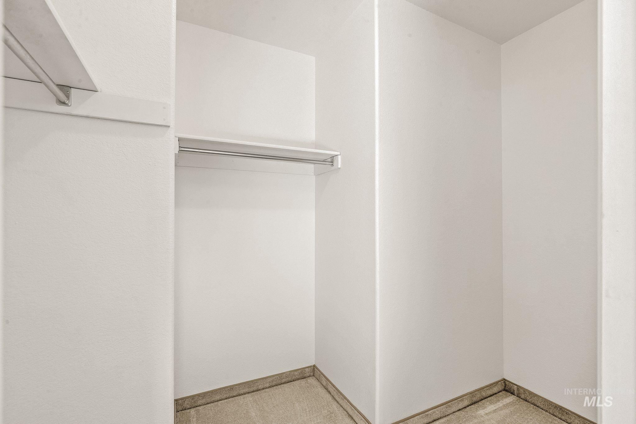 1091 Cedar Ridge Road Kendrick, ID 83537 - Photo 40 of 48 Walk-in closet featuring white walls, carpet flooring, and integrated chrome hanging rods