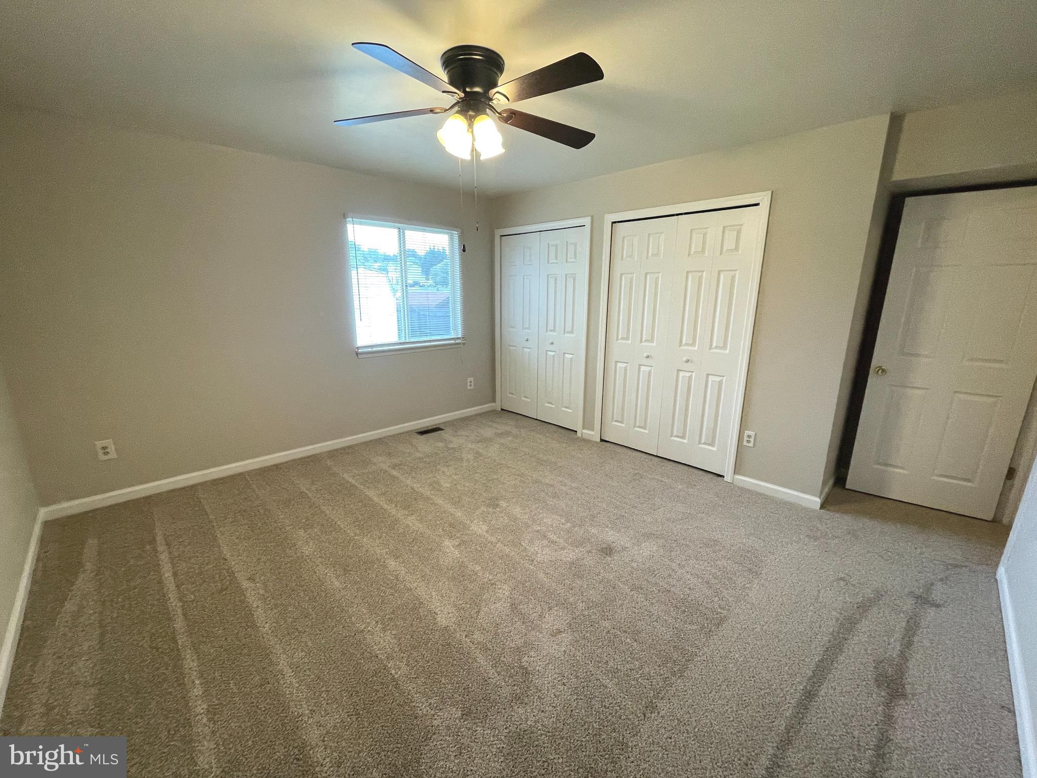 7944 Tick Neck Road Pasadena, MD 21122 - Photo 18 of 40 en empty room with windows and fan