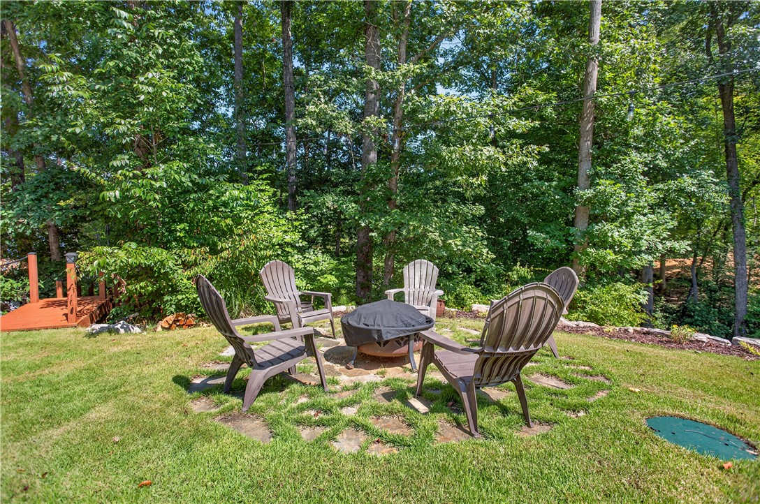 321 High Hampton Road Salem, SC 29676 - Photo 37 of 46 Stone pavers define a rustic gathering space surrounded by mature trees.