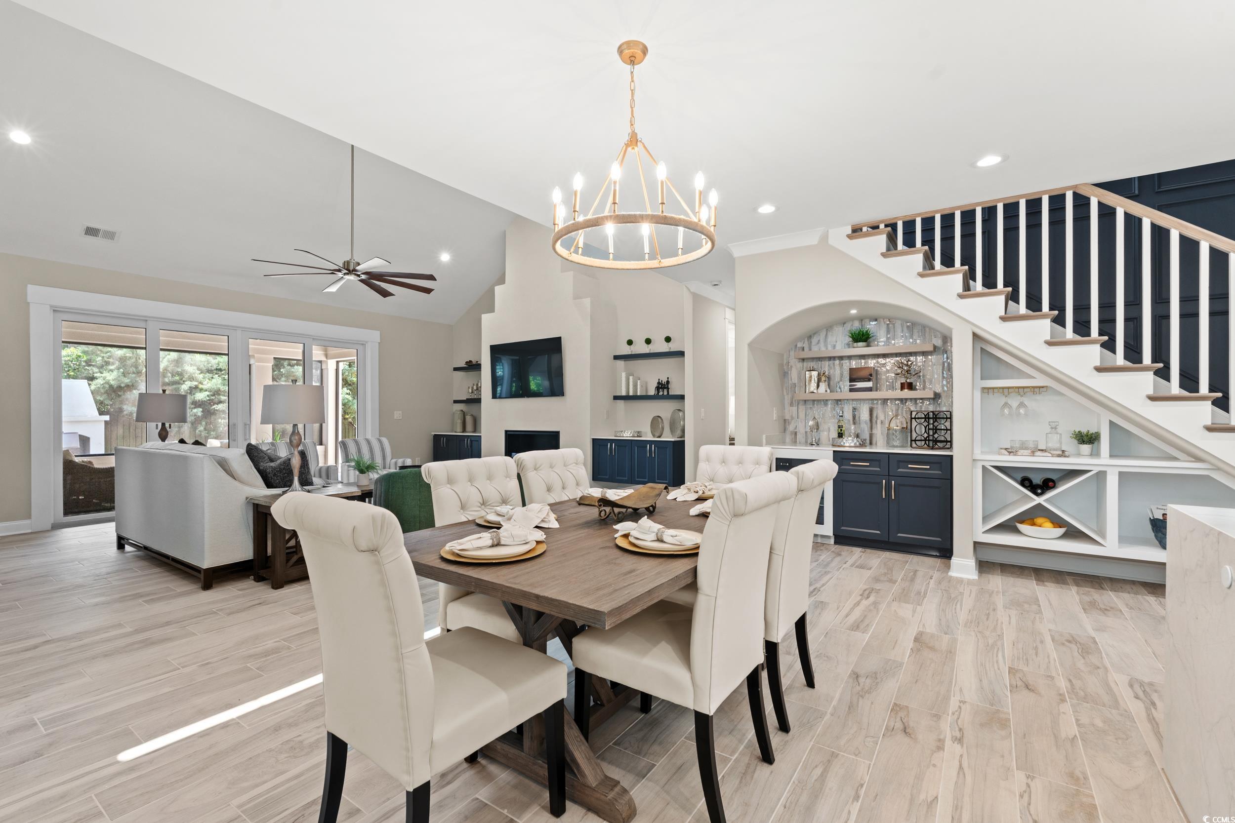 405 North Highland Way Myrtle Beach, SC 29572 - Photo 11 of 40 Dining room featuring a chandelier, light wood finished floors, recessed lighting, bar area, and stairway