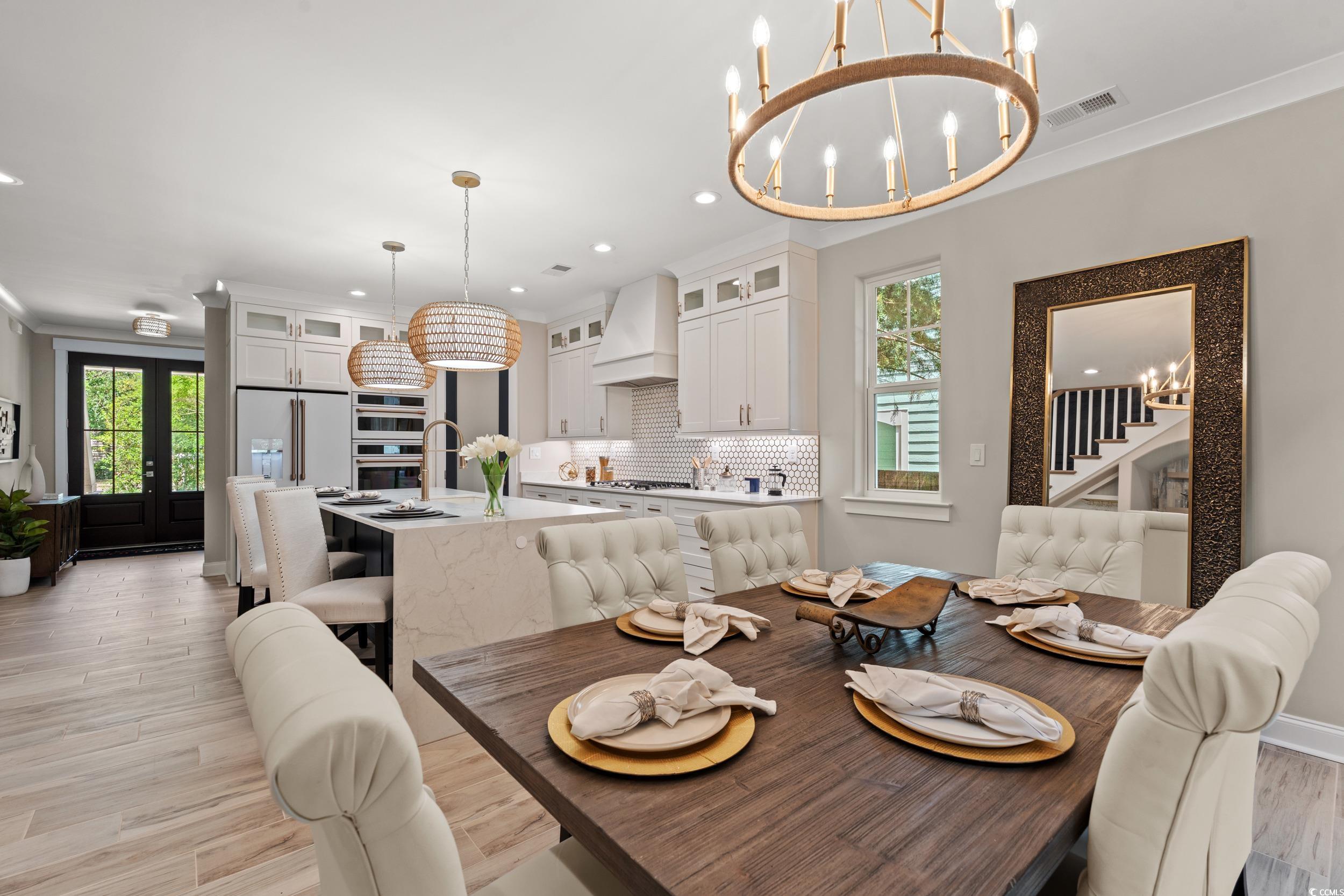 405 North Highland Way Myrtle Beach, SC 29572 - Photo 12 of 40 Dining room featuring a chandelier, stairway, light wood finished floors, recessed lighting, and ornamental molding