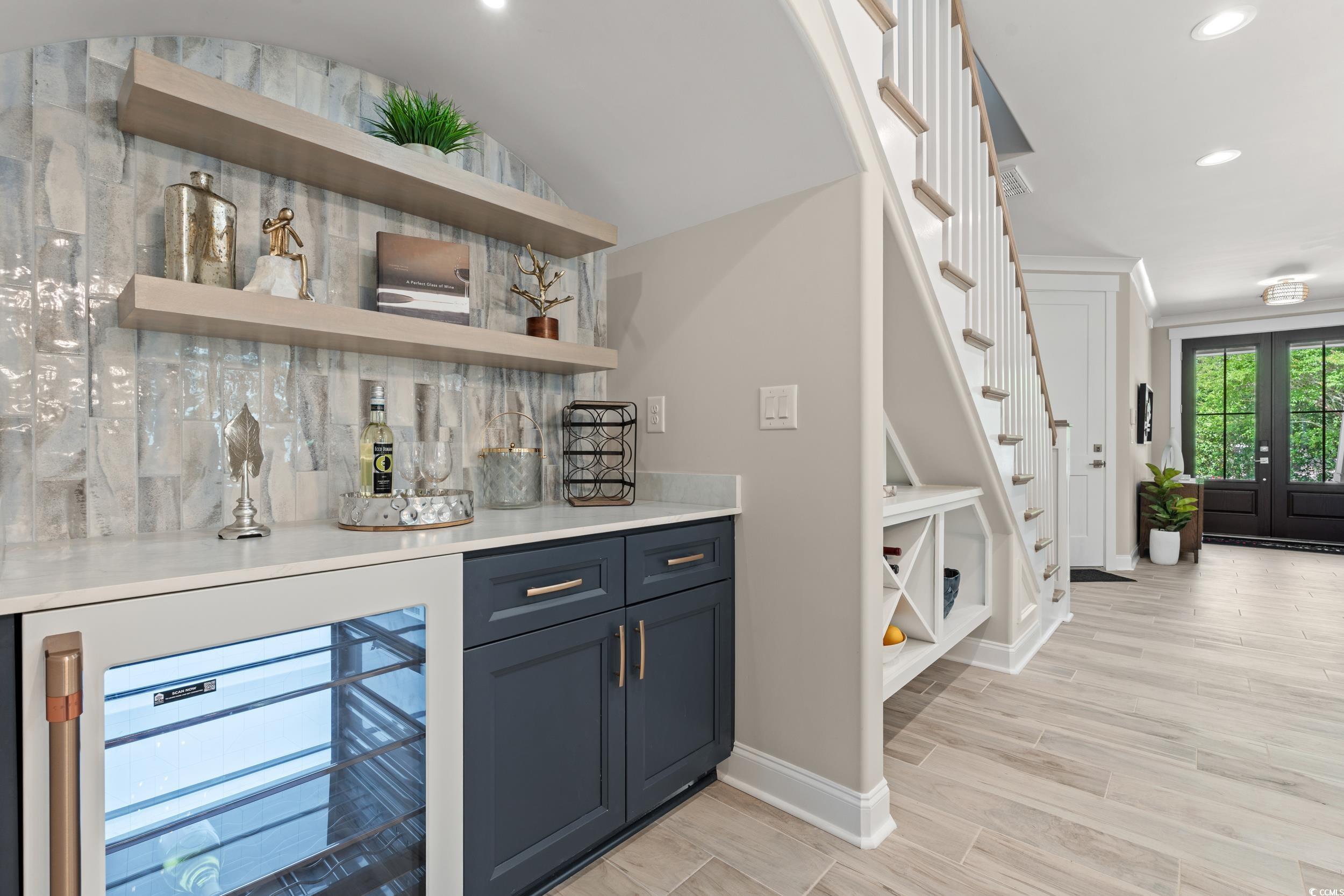 405 North Highland Way Myrtle Beach, SC 29572 - Photo 13 of 40 Indoor dry bar with beverage cooler, stairs, baseboards, tasteful backsplash, and recessed lighting