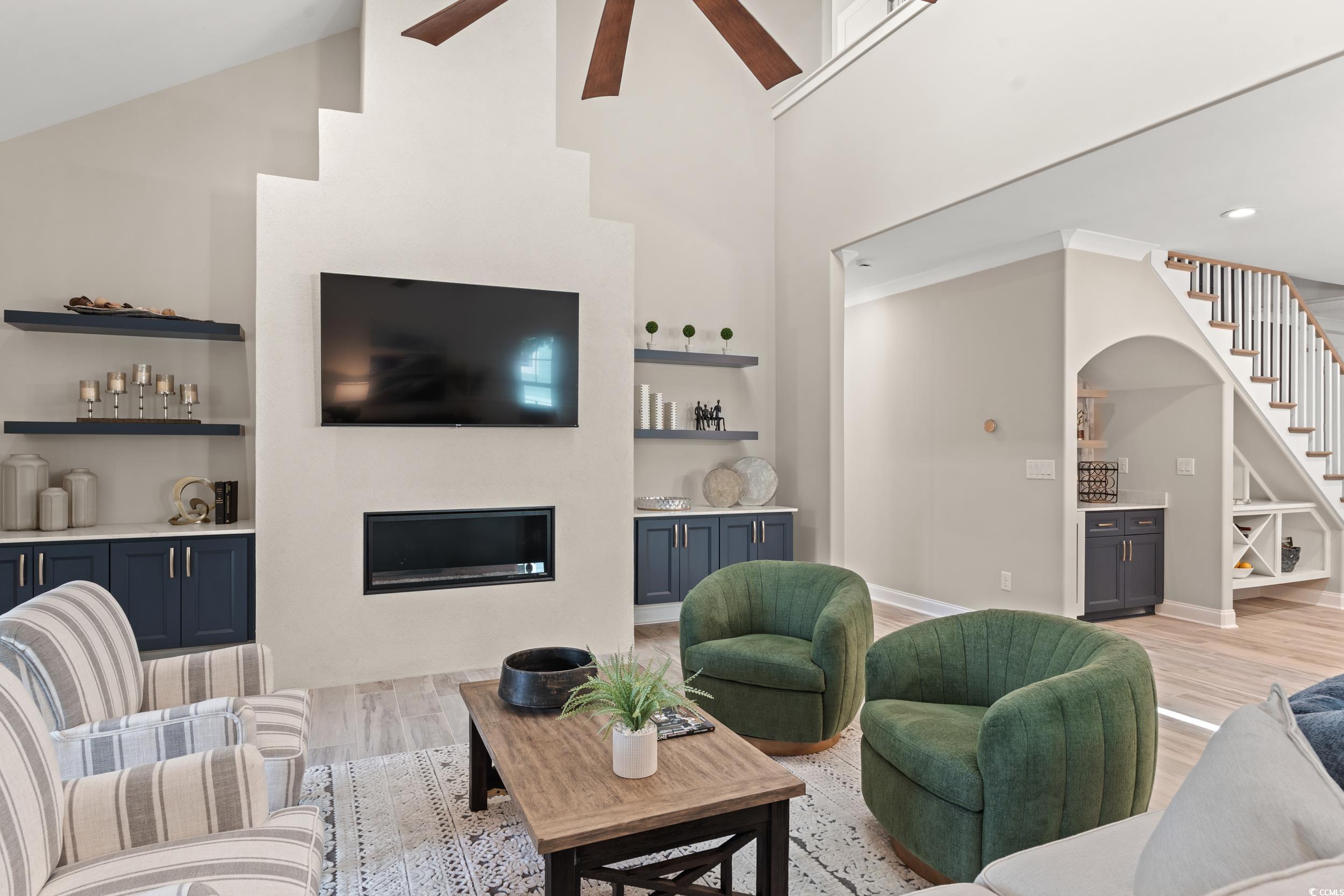 405 North Highland Way Myrtle Beach, SC 29572 - Photo 15 of 40 Living area featuring ceiling fan, built in shelves, light wood-style floors, stairway, and high vaulted ceiling