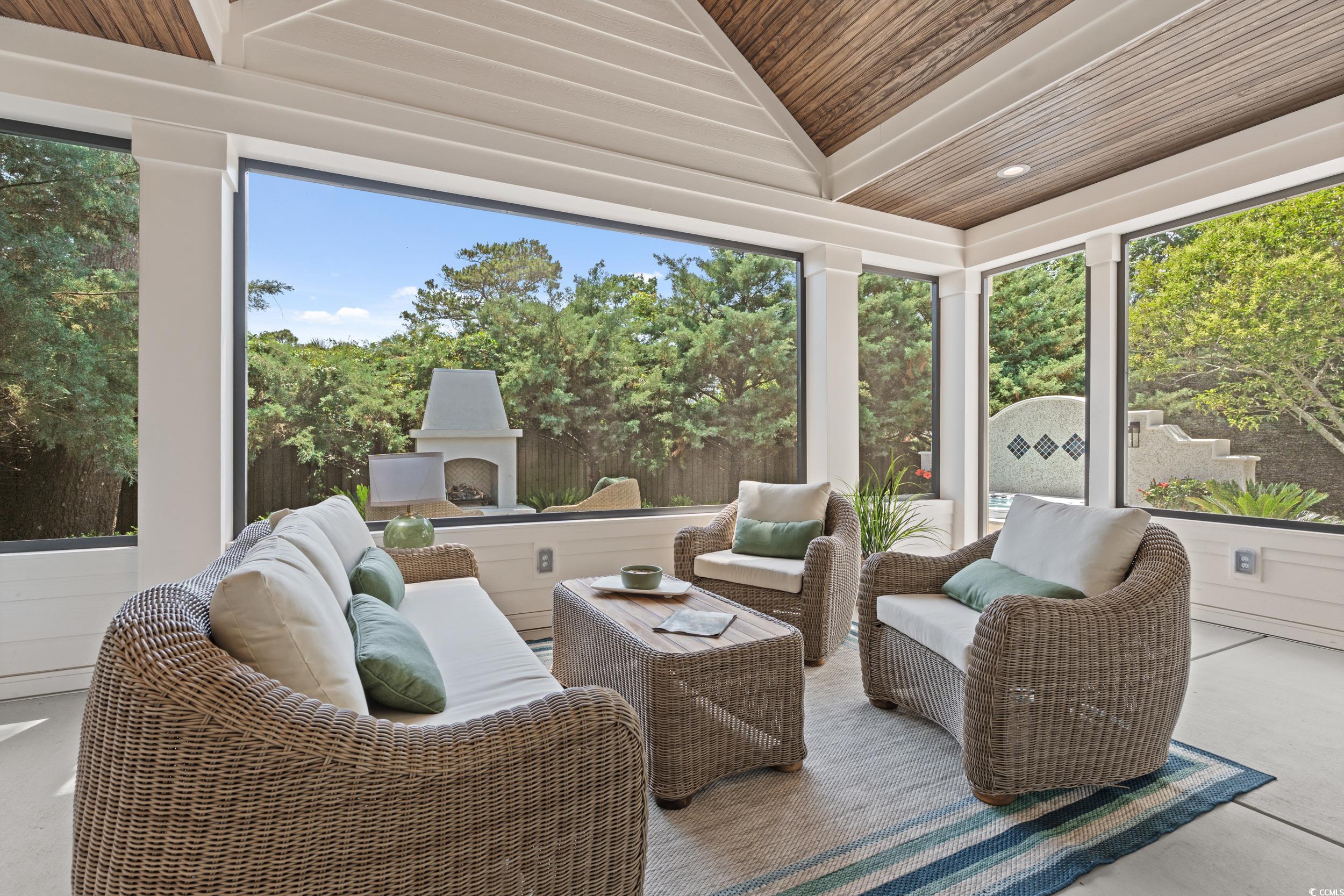 405 North Highland Way Myrtle Beach, SC 29572 - Photo 17 of 40 Sunroom / solarium with wooden ceiling, lofted ceiling, plenty of natural light, concrete flooring, and an outdoor living space with a fireplace