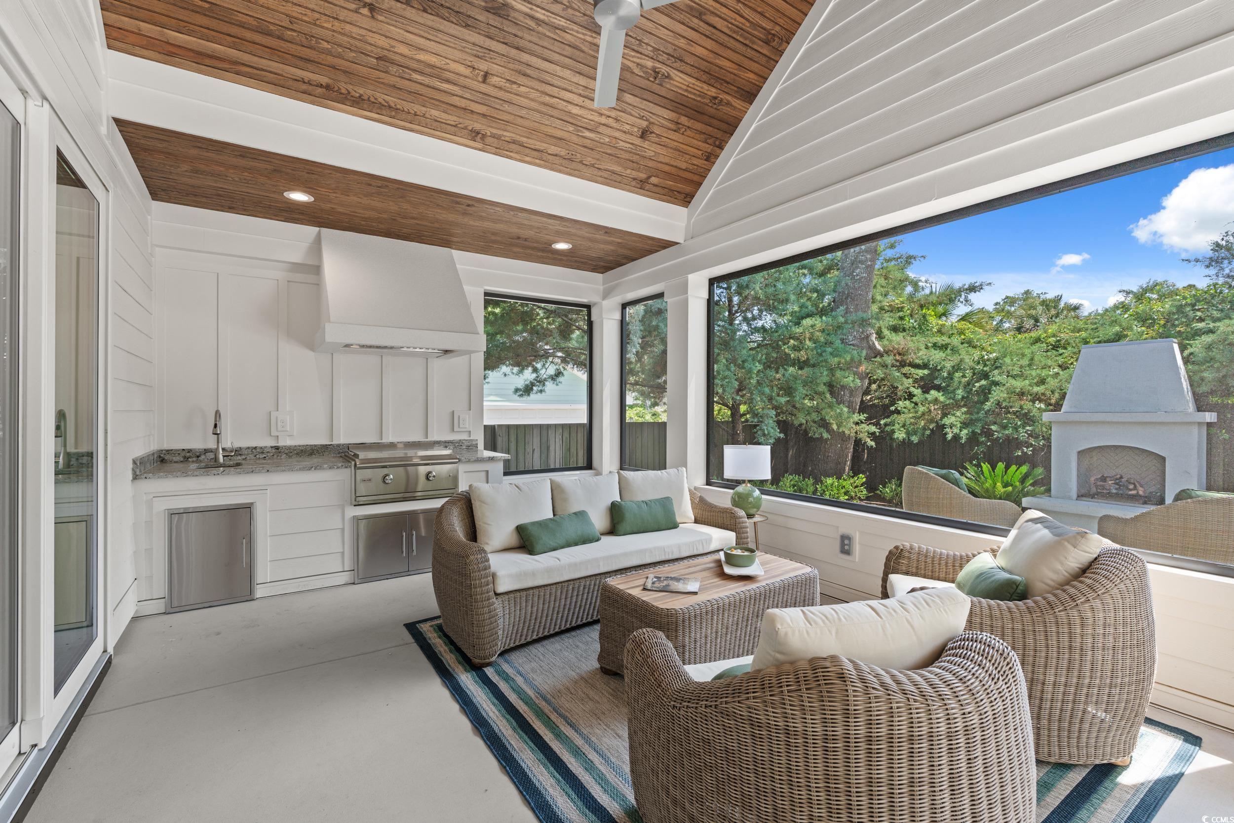 405 North Highland Way Myrtle Beach, SC 29572 - Photo 18 of 40 Living area featuring wooden ceiling, concrete floors, recessed lighting, bar with sink, and high vaulted ceiling