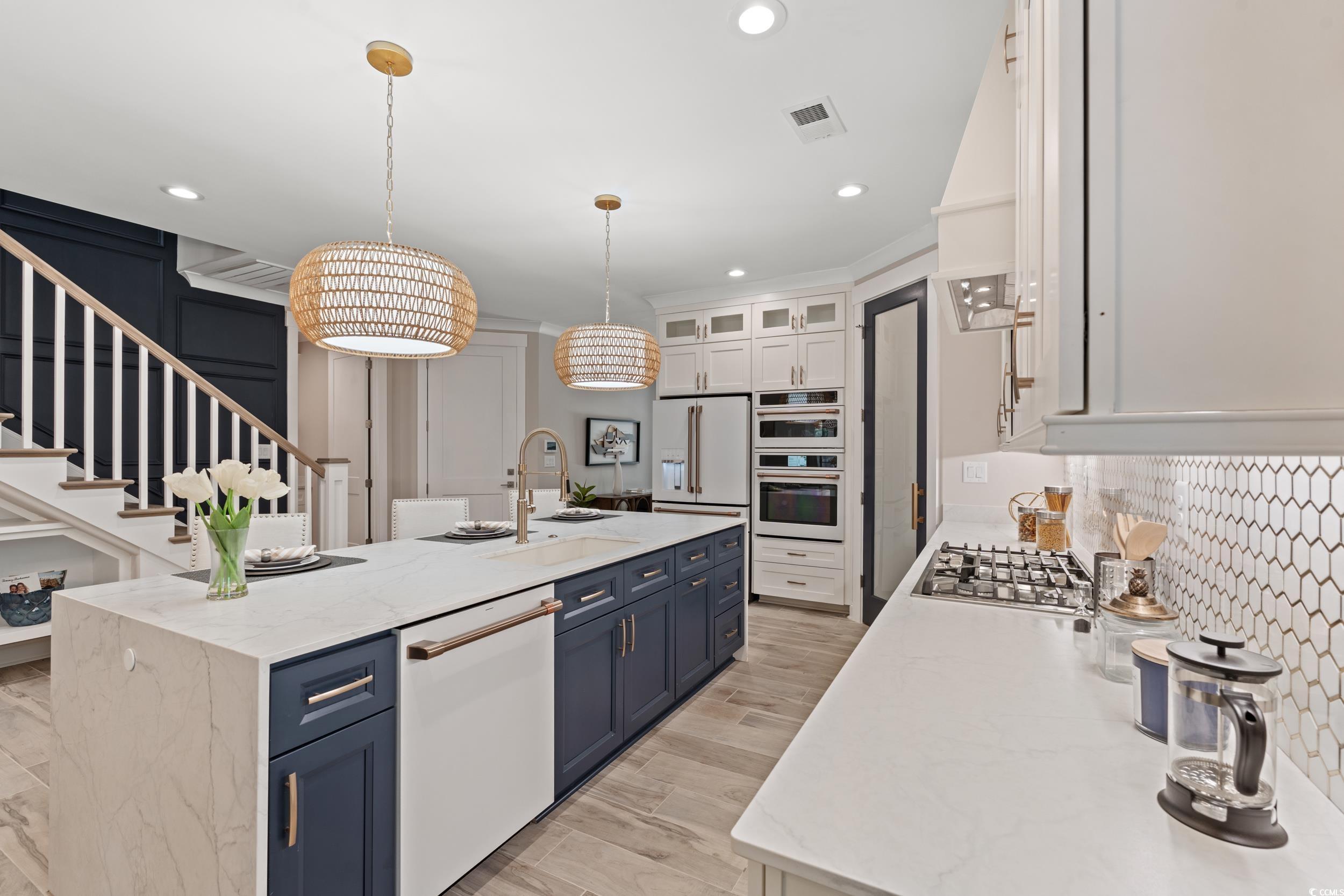 405 North Highland Way Myrtle Beach, SC 29572 - Photo 10 of 40 Kitchen with white appliances, a sink, blue cabinets, a kitchen island with sink, and recessed lighting