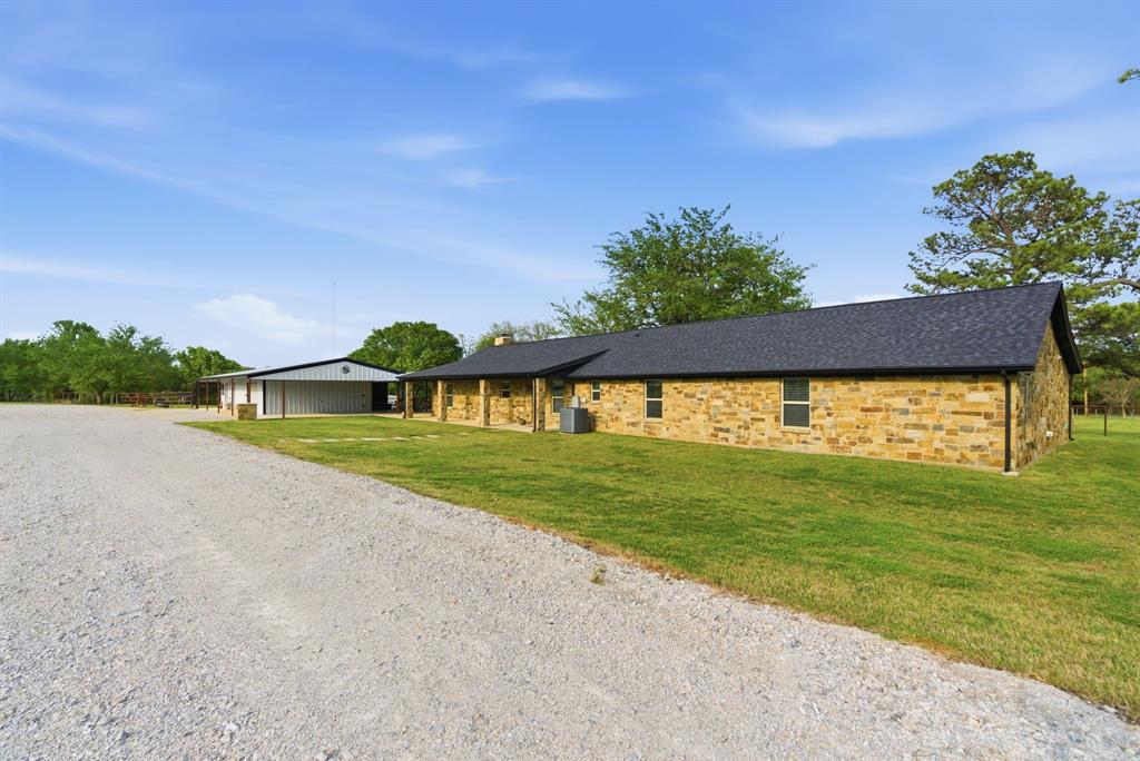 187 County Road 4195 Decatur, TX 76234 - Photo 39 of 40 a view of a big house with a big yard and a large trees