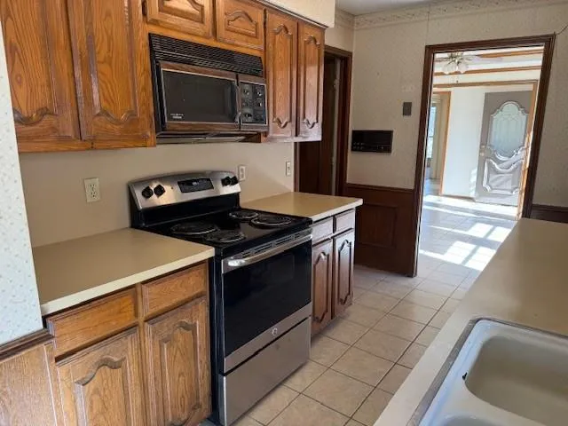 a kitchen with a stove microwave and sink