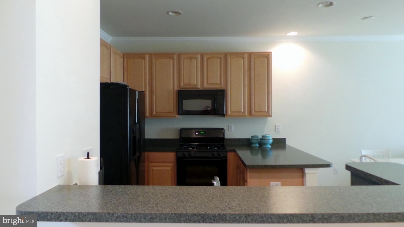 508 Summerset Court, Unit 33 Solomons, MD 20629 - Photo 11 of 36 a kitchen with a refrigerator and a stove
