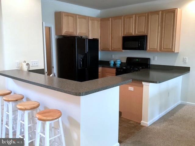 508 Summerset Court, Unit 33 Solomons, MD 20629 - Photo 12 of 36 a kitchen with stainless steel appliances granite countertop a refrigerator and a stove top oven
