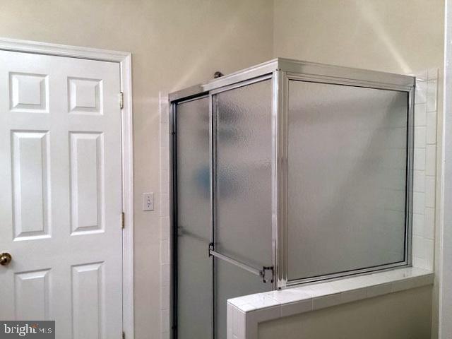 508 Summerset Court, Unit 33 Solomons, MD 20629 - Photo 17 of 36 a bathroom with a glass shower door