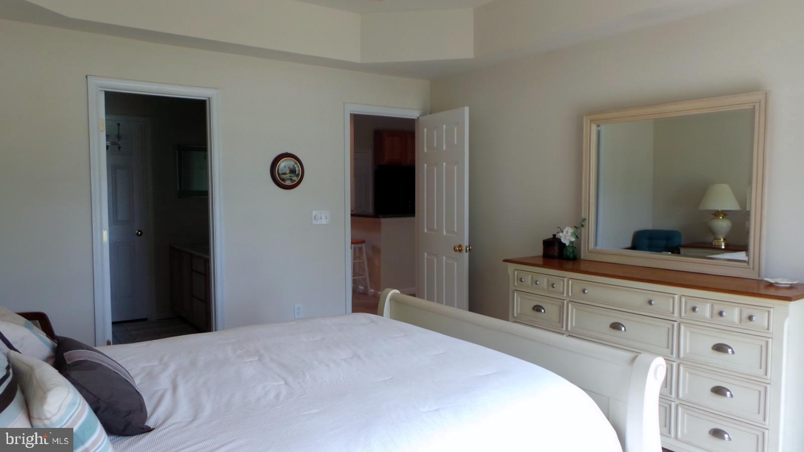 508 Summerset Court, Unit 33 Solomons, MD 20629 - Photo 18 of 36 a bedroom with a bed and a mirror